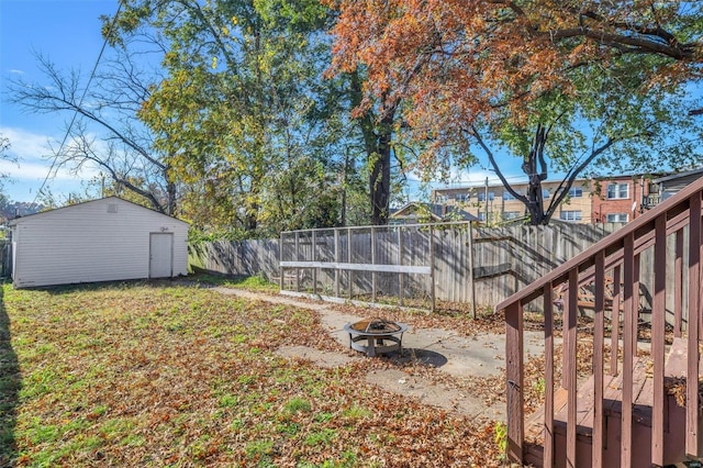 view of yard featuring a fire pit and a shed