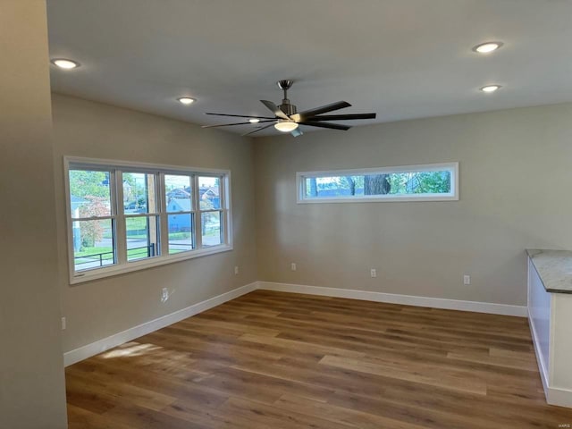 spare room with dark hardwood / wood-style flooring and ceiling fan