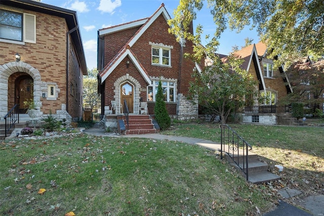 tudor home with a front lawn