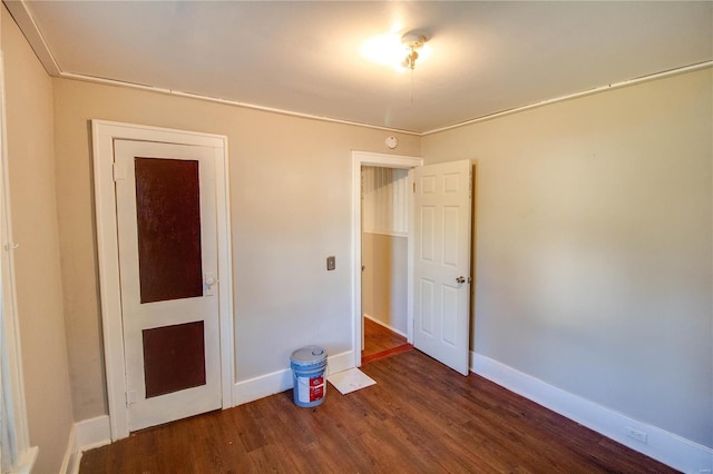 unfurnished bedroom featuring dark wood-type flooring