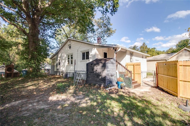 back of house featuring central AC