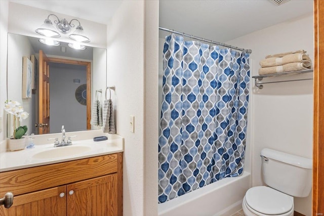 full bathroom with vanity, shower / bath combo, and toilet