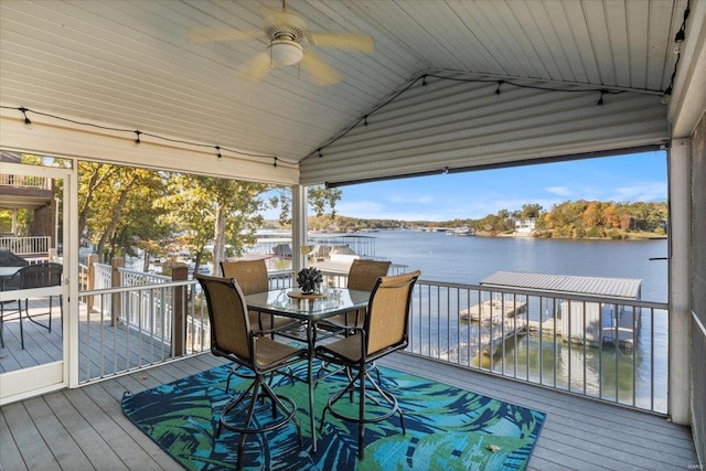 wooden terrace with a water view and ceiling fan