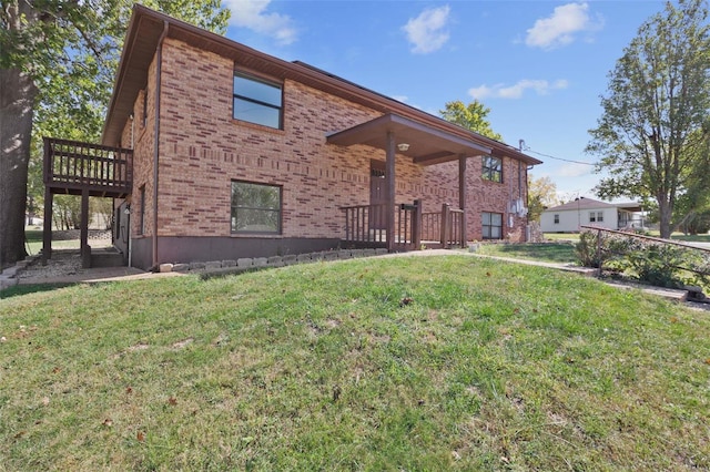 rear view of property with a yard