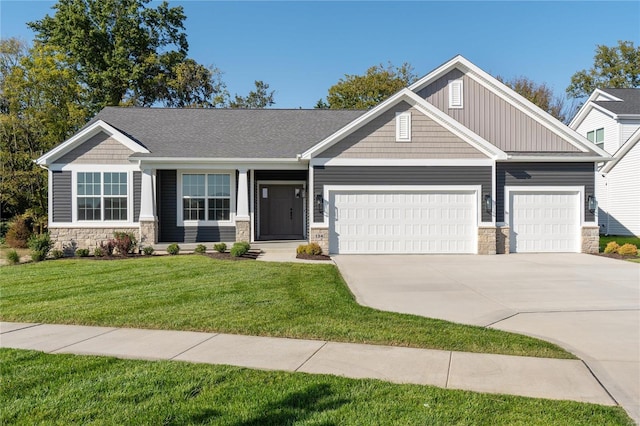 craftsman house with a front yard and a garage