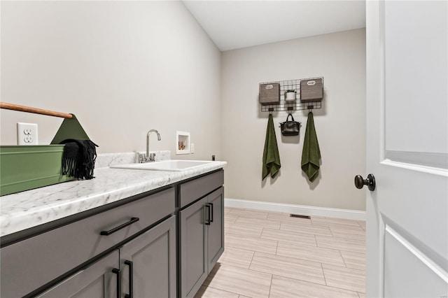 laundry room featuring cabinets, sink, and hookup for a washing machine