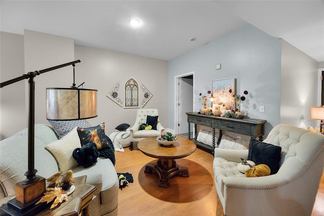 living room featuring hardwood / wood-style flooring and vaulted ceiling