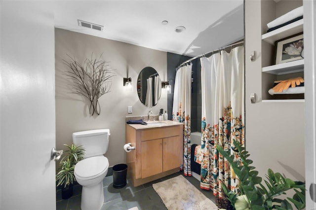 bathroom with vanity, toilet, and tile patterned floors