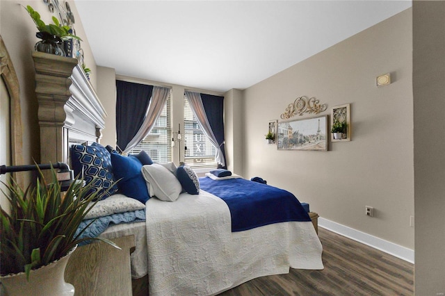 bedroom with dark hardwood / wood-style floors