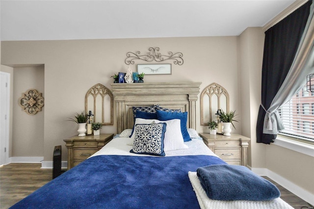 bedroom with dark hardwood / wood-style flooring