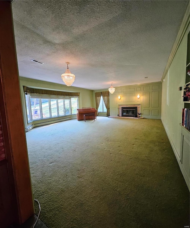 unfurnished living room with a wealth of natural light, carpet floors, and a textured ceiling