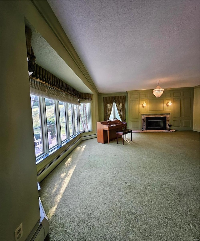 interior space with baseboard heating, a fireplace, carpet, and a textured ceiling