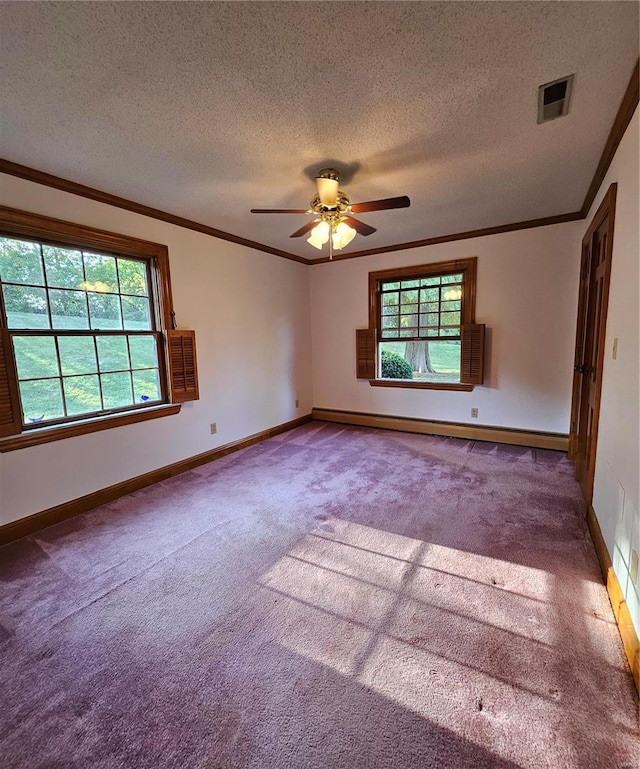 carpeted empty room with ceiling fan, a textured ceiling, a baseboard radiator, and a healthy amount of sunlight