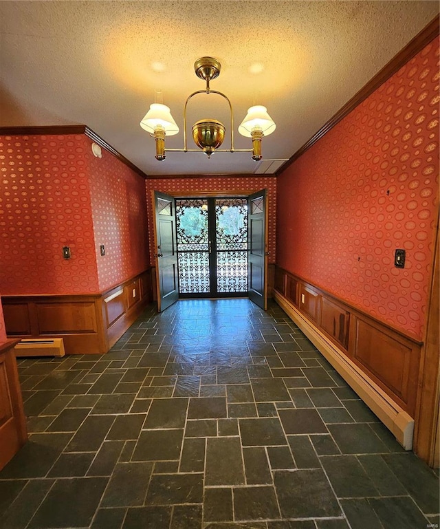 empty room featuring crown molding and a textured ceiling