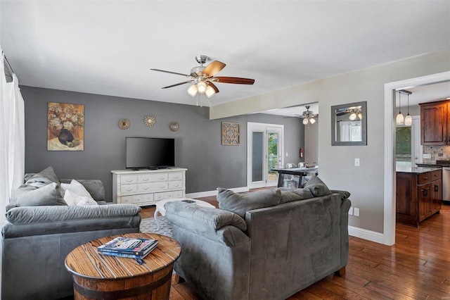 living room with ceiling fan and dark hardwood / wood-style flooring