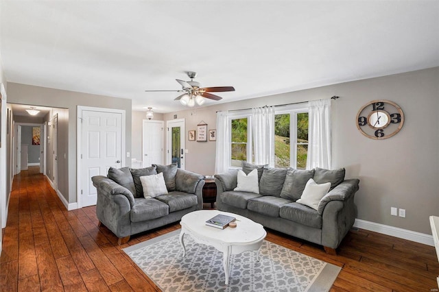 living room with ceiling fan and dark hardwood / wood-style flooring