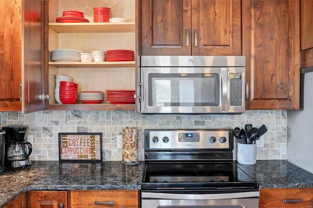 kitchen featuring dark stone countertops, stainless steel appliances, and tasteful backsplash