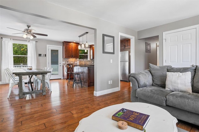 living room featuring hardwood / wood-style floors and ceiling fan