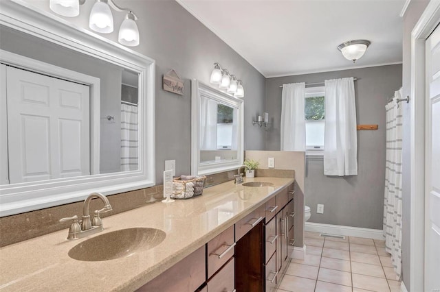 bathroom featuring toilet, crown molding, vanity, and tile patterned flooring