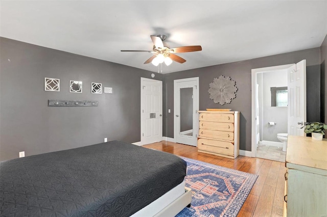 bedroom featuring hardwood / wood-style floors, connected bathroom, and ceiling fan