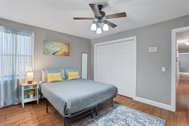 bedroom with hardwood / wood-style floors, a closet, and ceiling fan