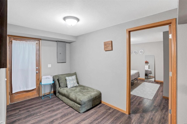 sitting room featuring a textured ceiling, electric panel, and dark hardwood / wood-style flooring