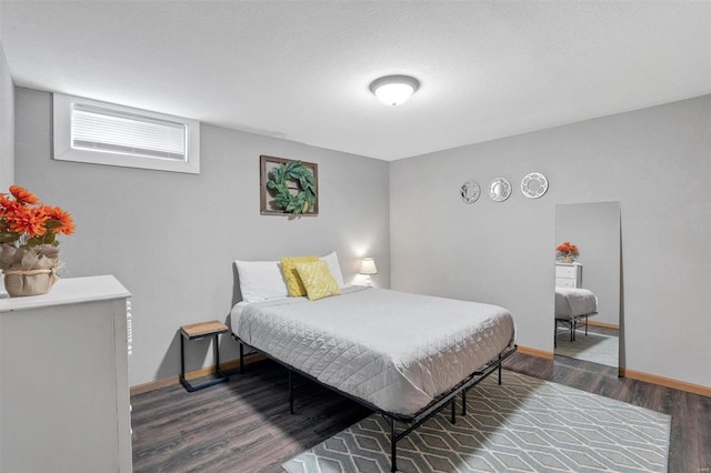 bedroom with dark hardwood / wood-style floors