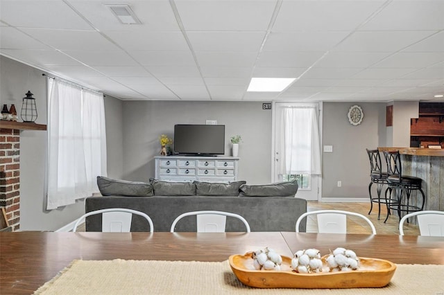 living room with a drop ceiling