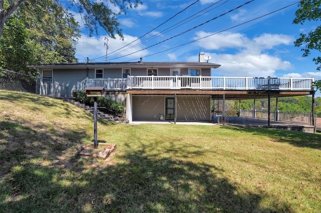 back of property featuring a deck and a lawn