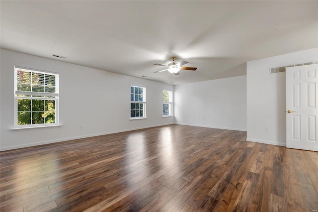 spare room featuring ceiling fan and dark wood-type flooring