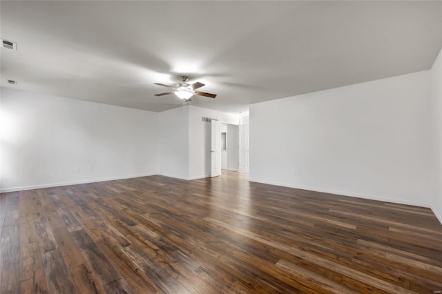 empty room featuring dark wood-type flooring and ceiling fan