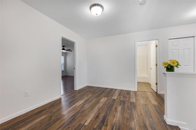 empty room with dark hardwood / wood-style flooring