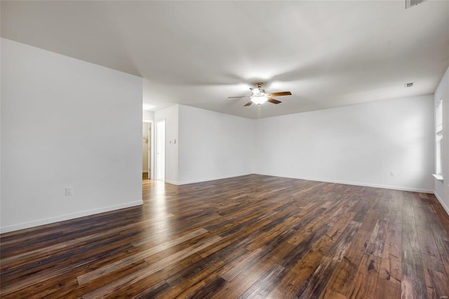 spare room with dark hardwood / wood-style floors and ceiling fan