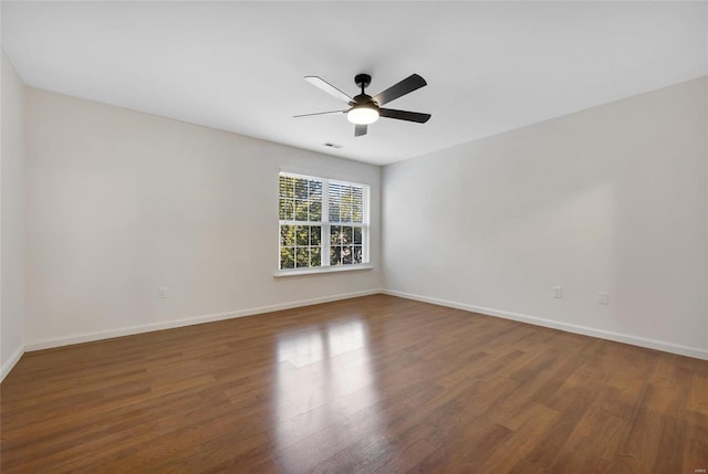 unfurnished room with ceiling fan and dark wood-type flooring