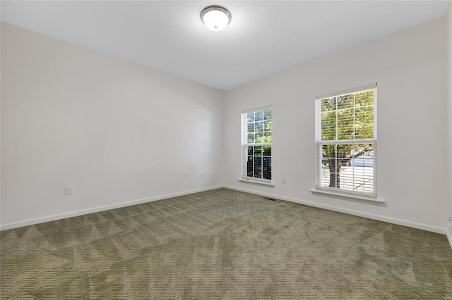 unfurnished room featuring dark carpet