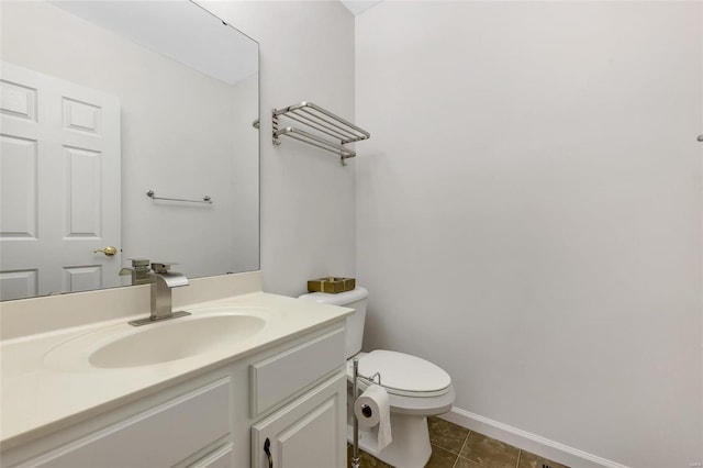 bathroom featuring tile patterned floors, vanity, and toilet