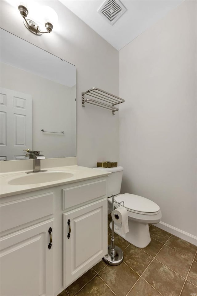 bathroom with vanity, tile patterned flooring, and toilet