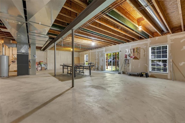 basement featuring water heater and heating unit