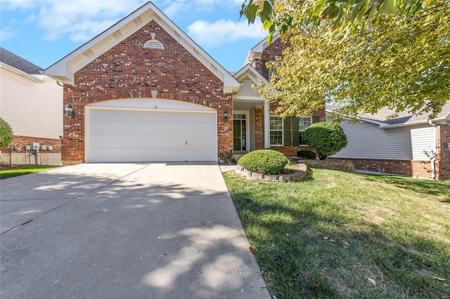 view of front of home with a front yard and a garage