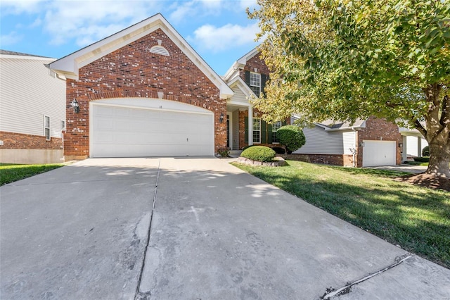 view of front facade featuring a front yard and a garage