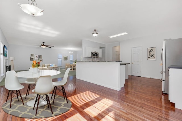 dining area featuring ceiling fan and wood-type flooring