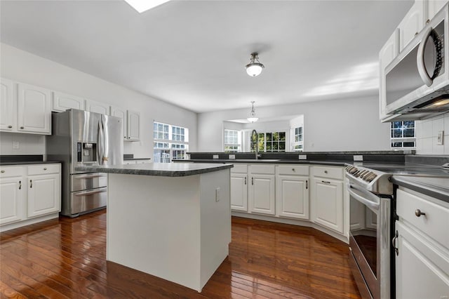 kitchen with white cabinetry, dark wood-type flooring, and appliances with stainless steel finishes