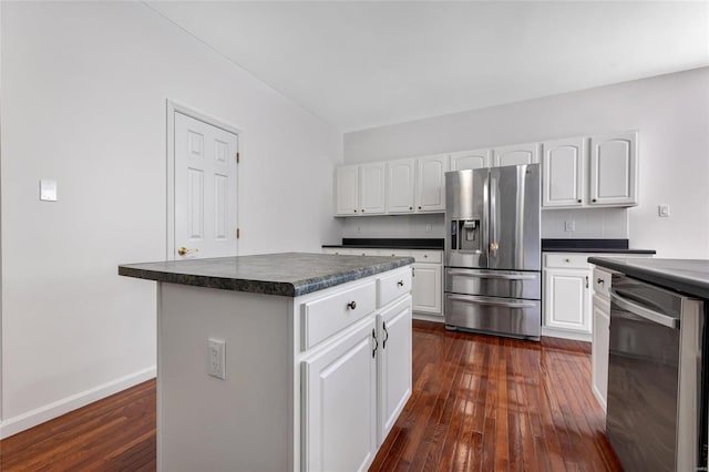 kitchen featuring white cabinets, stainless steel appliances, a kitchen island, and dark hardwood / wood-style floors