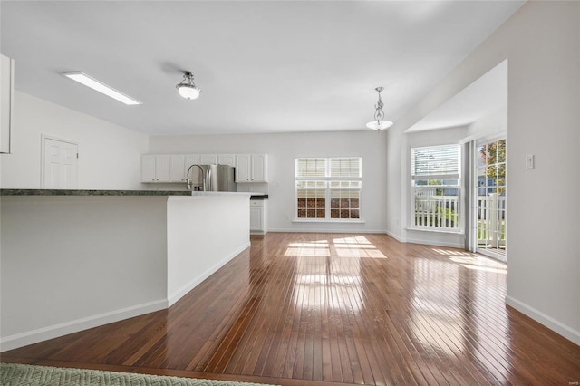 unfurnished living room featuring dark hardwood / wood-style flooring