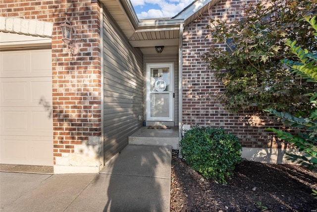 doorway to property with a garage