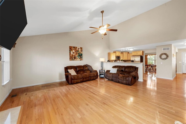 living room featuring light wood-type flooring, high vaulted ceiling, and ceiling fan