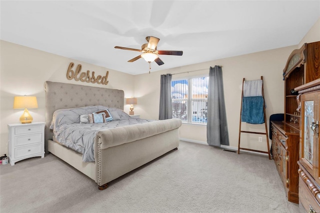 bedroom featuring light colored carpet and ceiling fan