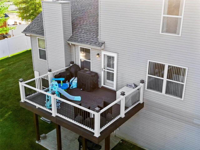 wooden terrace featuring a yard