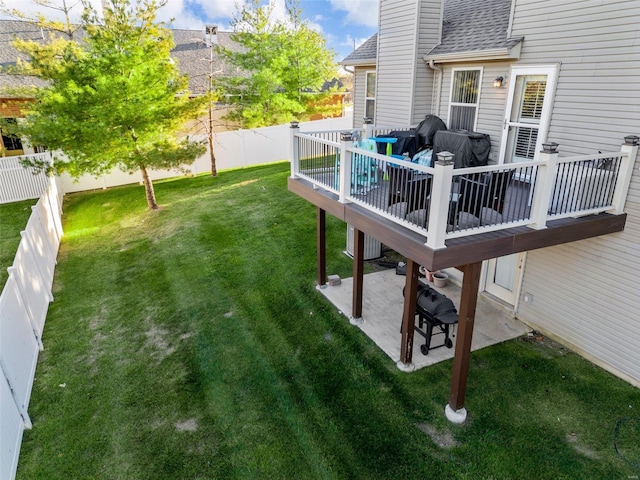 view of yard featuring a wooden deck and a patio