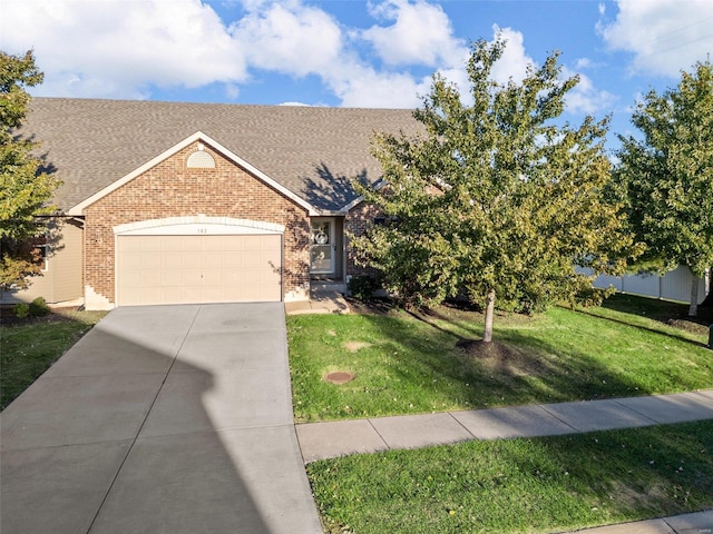 view of front of home with a garage and a front lawn